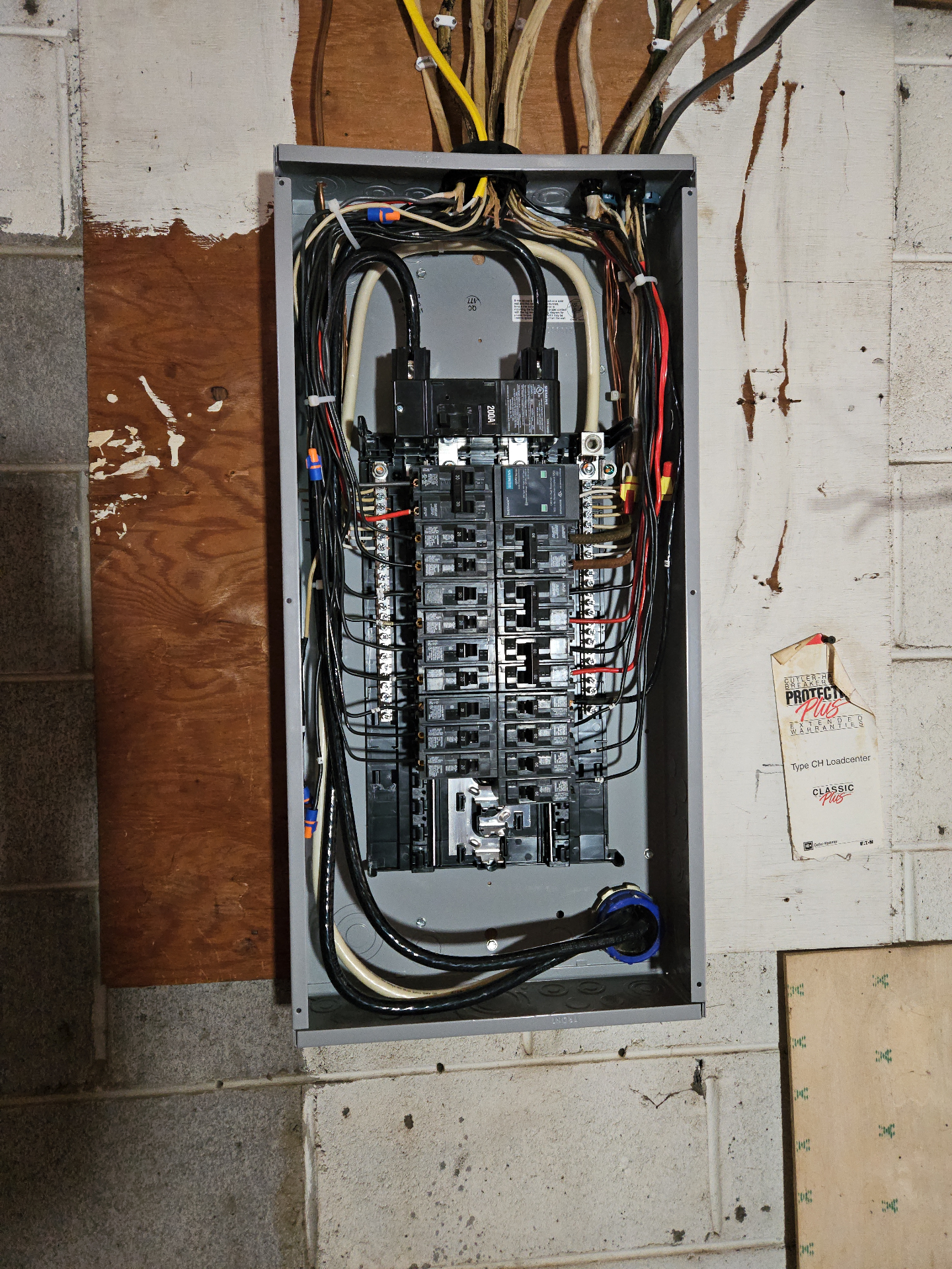 Newly installed 200-amp electrical panel with neatly organized breakers and wiring